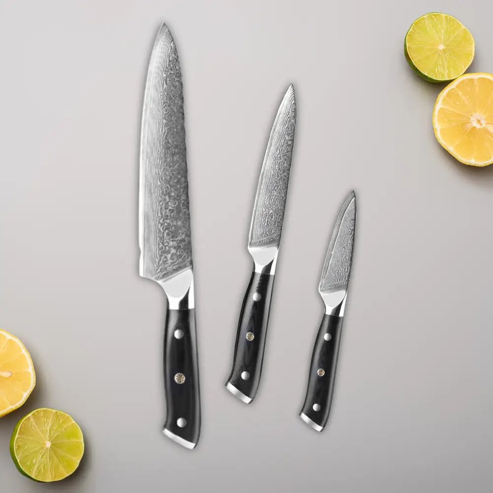 3 Piece Damascus Steel Knife Set (Executive Series) with lemons.