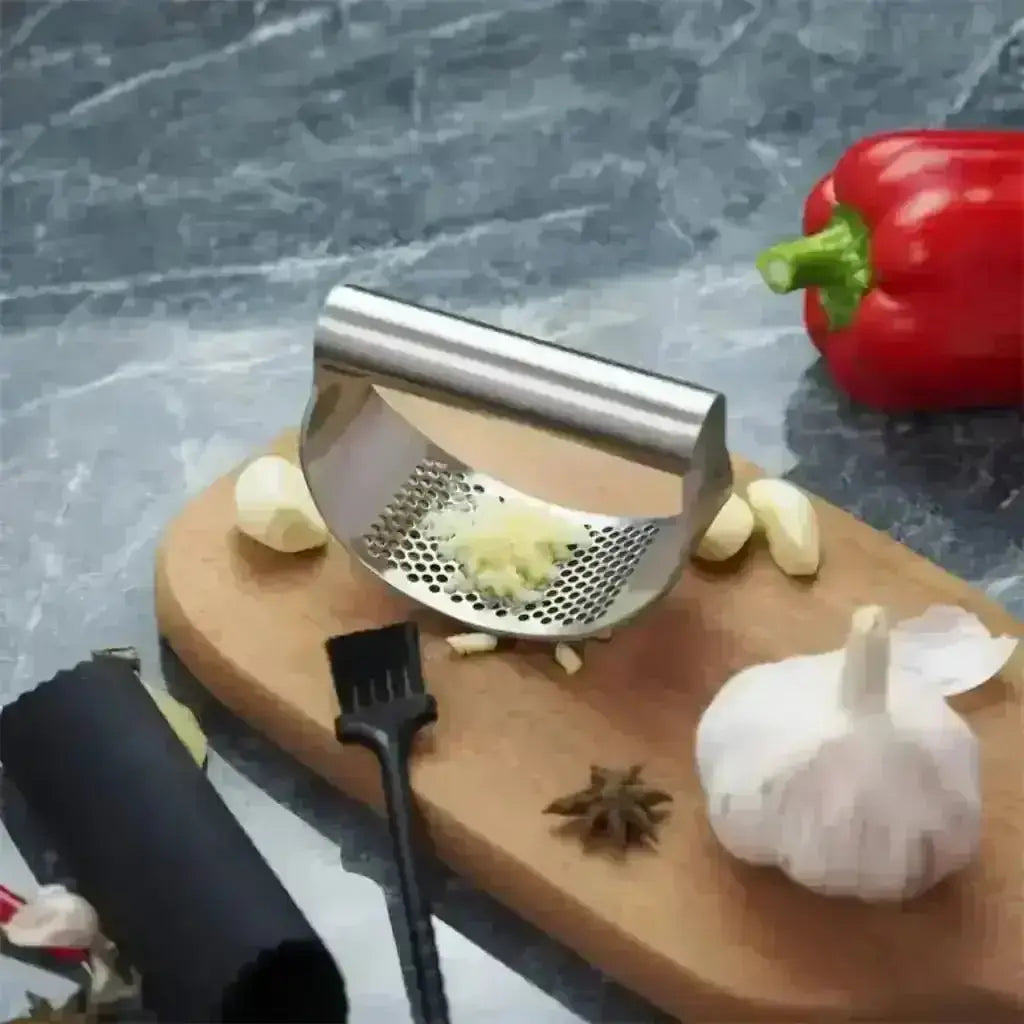 Stainless Steel Garlic Press - Garlic Crusher silver on cutting board