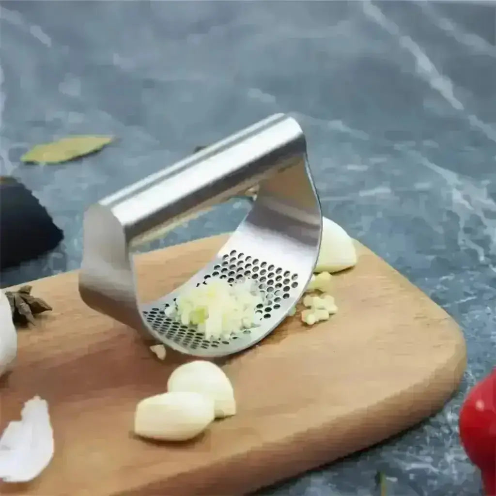 Stainless Steel Garlic Press - Garlic Crusher on cutting board